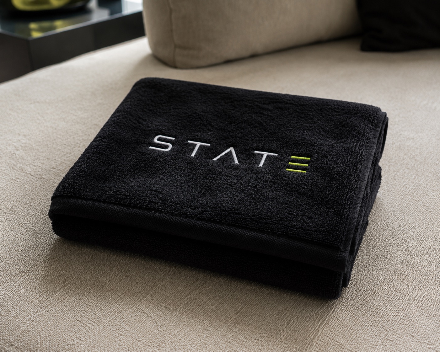Black STATE towel embroidered with the wordmark